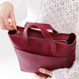 Berry Good Zipper | Model holding crossbody tote bag with zipper closure and front pocket