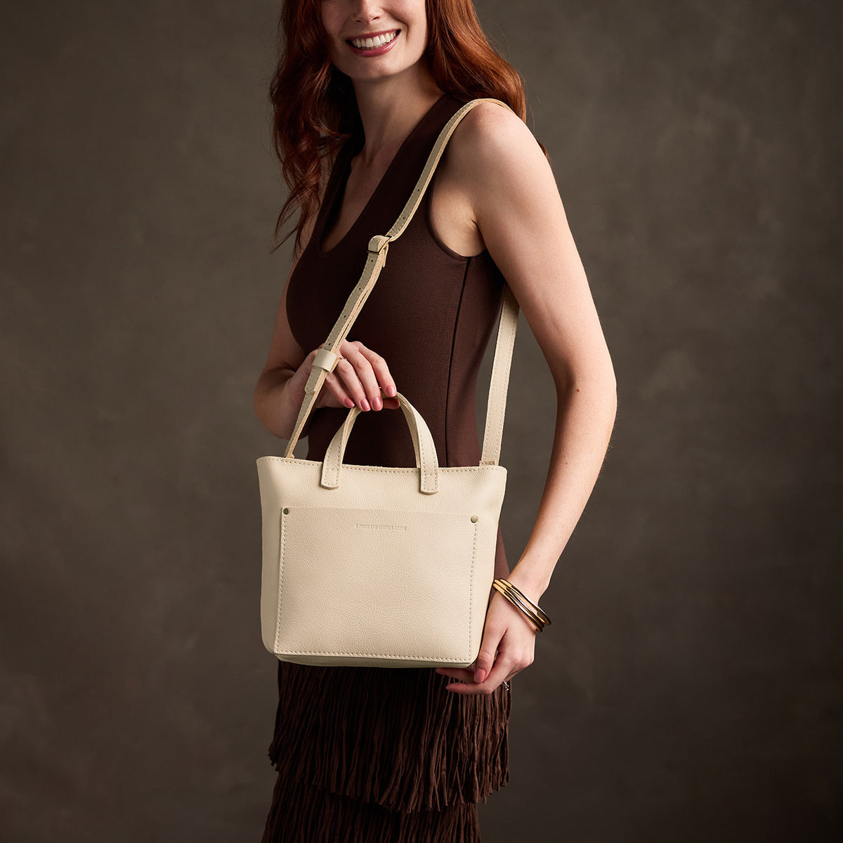 Pebbled Bone*Zipper | Model carrying crossbody tote bag with snap closure and front pocket