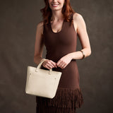 Pebbled Bone Zipper | Model carrying crossbody tote bag with snap closure and front pocket