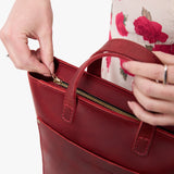 Phoenix Zipper | Model holding crossbody tote bag with zipper closure and front pocket