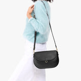 Black Large | Model wearing a leather Crossbody with a flap and magnetic closure