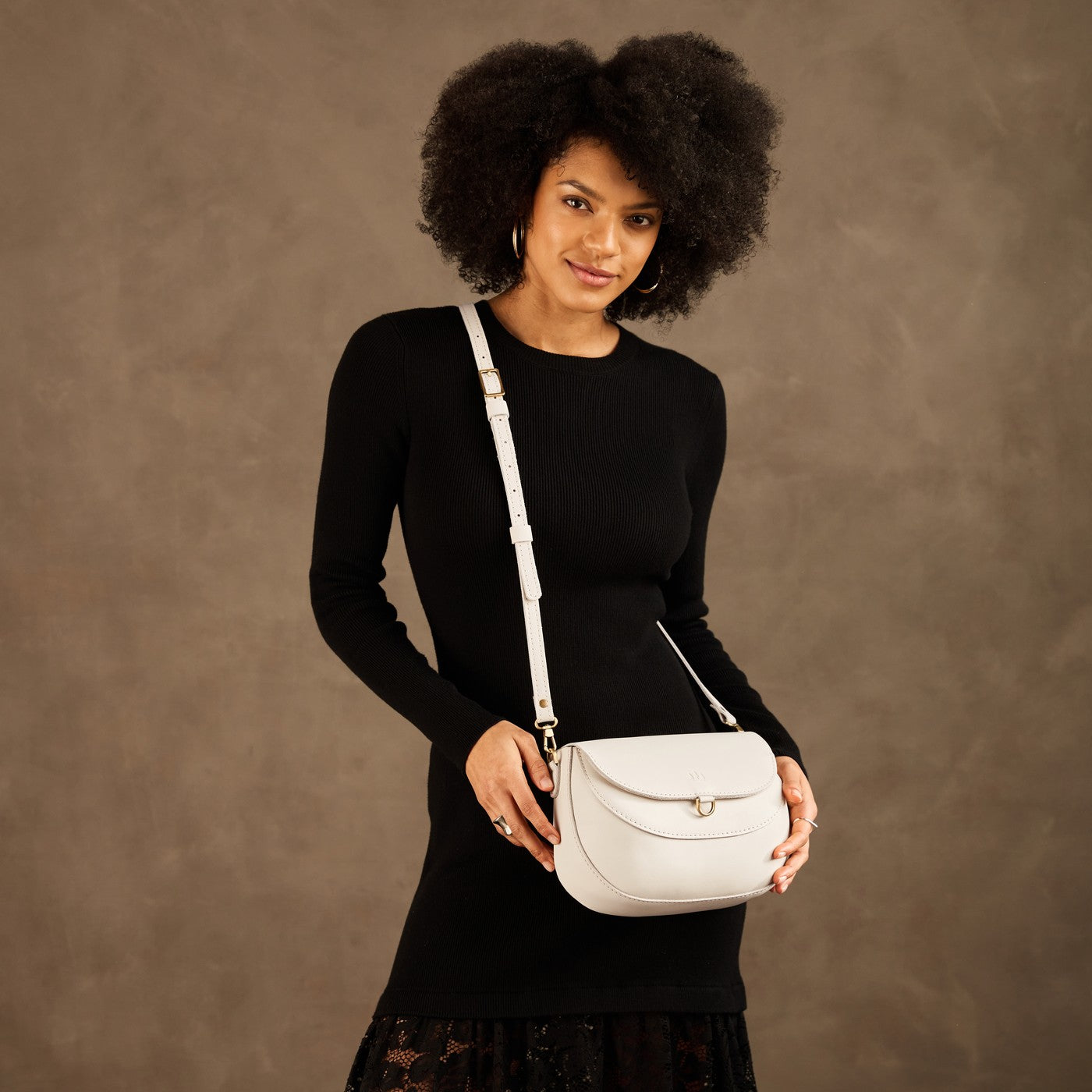 Bone*Large | Model wearing a leather Crossbody with a flap and magnetic closure