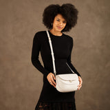 Bone Large | Model wearing a leather Crossbody with a flap and magnetic closure
