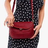 Chili Red Large | Model wearing a leather Crossbody with a flap and magnetic closure
