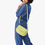 Wasabi Large | Model wearing a petite leather Crossbody with a flap and magnetic closure