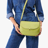 Wasabi Large | Model wearing a petite leather Crossbody with a flap and magnetic closure