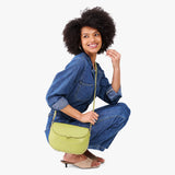 Wasabi Large | Model wearing a petite leather Crossbody with a flap and magnetic closure