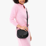 Black Small | Model wearing a petite leather Crossbody with a flap and magnetic closure