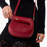 Chili Red Small | Model wearing a petite leather Crossbody with a flap and magnetic closure