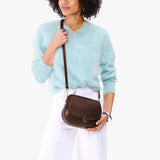 Chocolate Brown Small | Model wearing a petite leather Crossbody with a flap and magnetic closure
