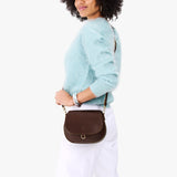 Chocolate Brown Small | Model wearing a petite leather Crossbody with a flap and magnetic closure