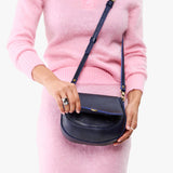 Cobalt Small | Model wearing a petite leather Crossbody with a flap and magnetic closure