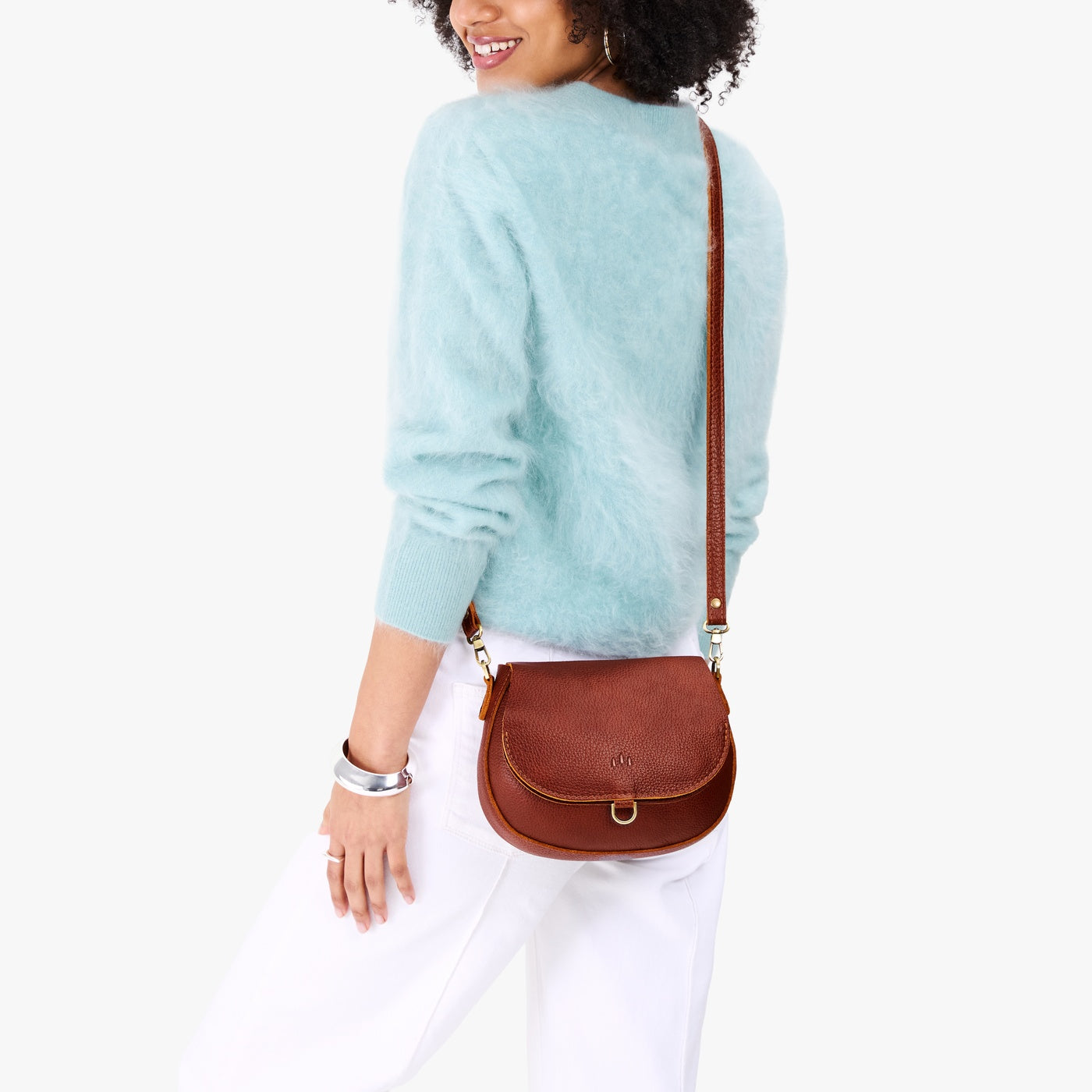 Nutmeg*Small | Model wearing a petite leather Crossbody with a flap and magnetic closure