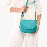 Seafoam Small | Model wearing a petite leather Crossbody with a flap and magnetic closure
