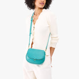 Seafoam Small | Model wearing a petite leather Crossbody with a flap and magnetic closure