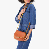 Sienna Small | Model wearing a petite leather Crossbody with a flap and magnetic closure