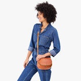 Sienna Small | Model wearing a petite leather Crossbody with a flap and magnetic closure