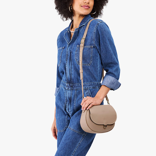 Stone*Small | Model wearing a petite leather Crossbody with a flap and magnetic closure