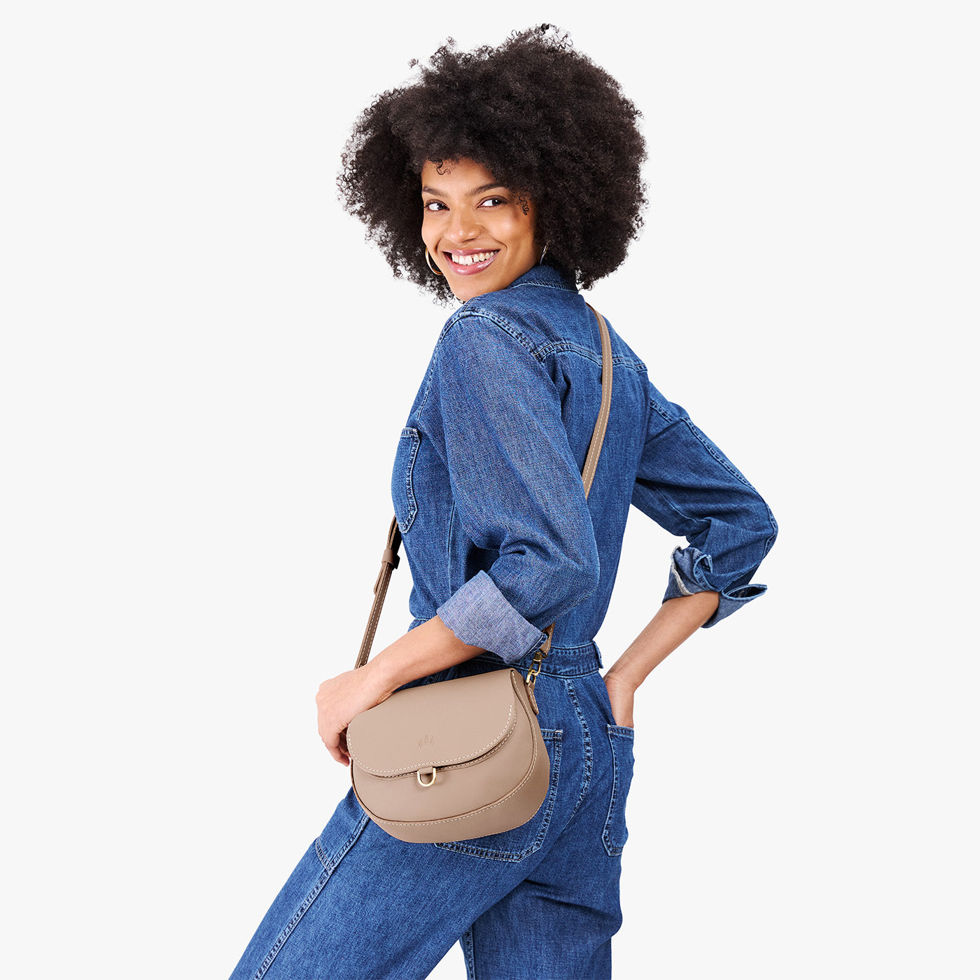 Stone*Small | Model wearing a petite leather Crossbody with a flap and magnetic closure