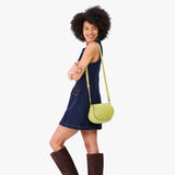 Wasabi Small | Model wearing a petite leather Crossbody with a flap and magnetic closure