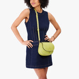 Wasabi Small | Model wearing a petite leather Crossbody with a flap and magnetic closure