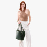 Evergreen | Model wearing leather tote bag with riveted straps and exterior key loop