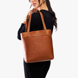 Honey | Model wearing leather tote bag with riveted straps and exterior key loop