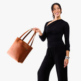 Honey | Model wearing leather tote bag with riveted straps and exterior key loop