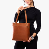 Honey | Model wearing leather tote bag with riveted straps and exterior key loop