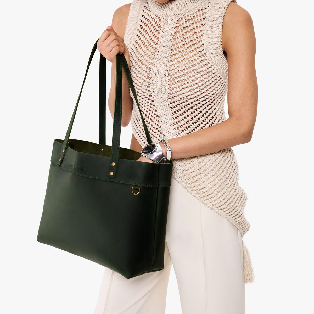 Evergreen*Large*Classic | Model wearing leather tote bag with riveted straps and exterior key loop