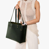 Evergreen Large Classic | Model wearing leather tote bag with riveted straps and exterior key loop