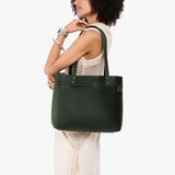 Evergreen Large Classic | Model wearing leather tote bag with riveted straps and exterior key loop