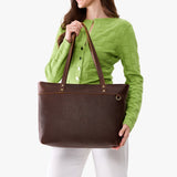 Coldbrew Large Zipper | Model wearing leather tote bag with riveted straps and exterior key loop