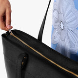 Pebbled--black Large Zipper | Model wearing leather tote bag with riveted straps and exterior key loop