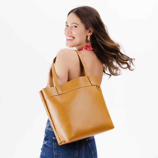 Mango | Model wearing leather tote bag with riveted straps and exterior key loop