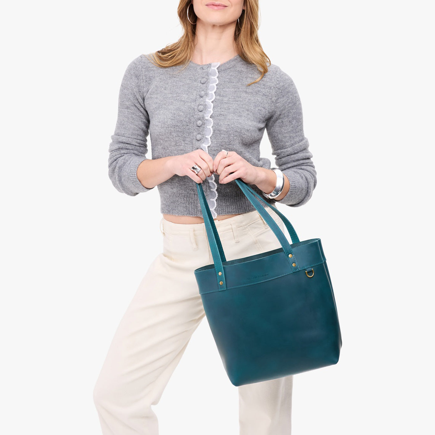 Westward Blue | Model wearing leather tote bag with riveted straps and exterior key loop