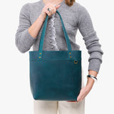 Westward Blue | Model wearing leather tote bag with riveted straps and exterior key loop