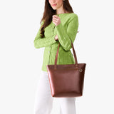 Cognac Medium Zipper | Model wearing leather tote bag with riveted straps and exterior key loop