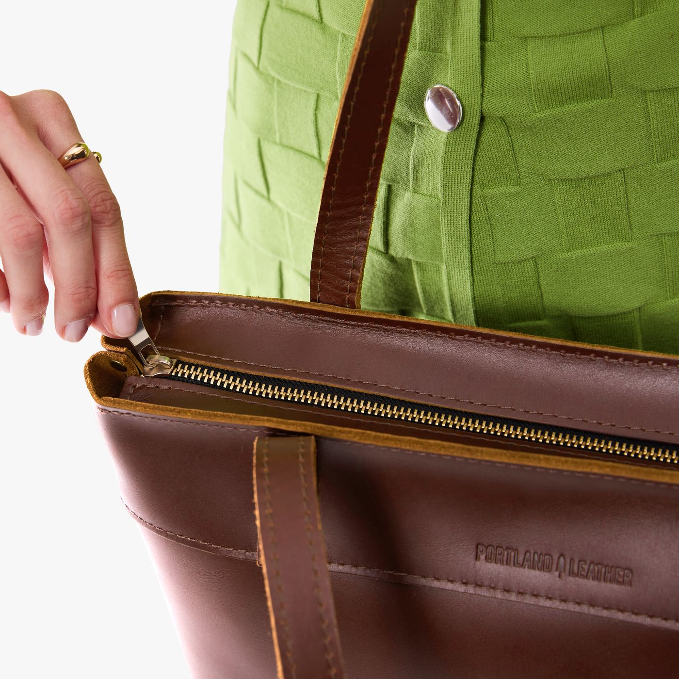 Cognac*Medium*Zipper  | Model wearing leather tote bag with riveted straps and exterior key loop