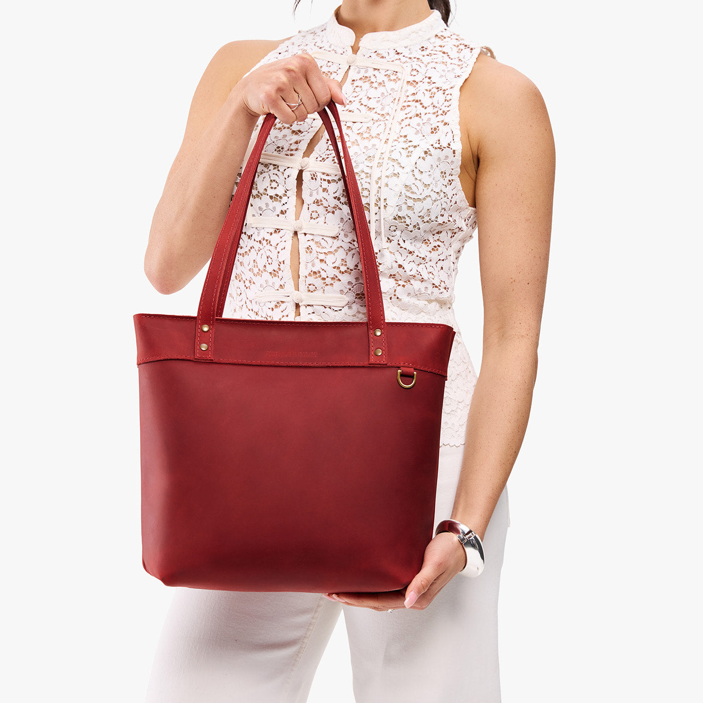Phoenix*Medium*Zipper | Model wearing leather tote bag with riveted straps and exterior key loop