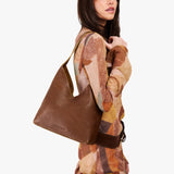 Asheville Large | Model wearing mid-size shoulder bag with magnetic snap closure