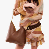 Asheville Large | Model wearing mid-size shoulder bag with magnetic snap closure