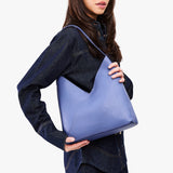 Aster Large | Model wearing mid-sized shoulder bag with magnetic snap 