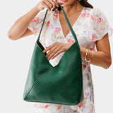 Bacalar Large | Model holding mid-size shoulder bag with magnetic snap closure