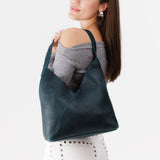 Boreal Large | Model wearing mid-size shoulder bag with magnetic snap closure