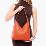Koi Large | Model wearing mid-size shoulder bag with magnetic snap 