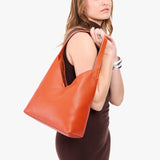 Koi Large | Model wearing mid-size shoulder bag with magnetic snap 