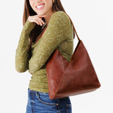 Nutmeg Large | Model wearing mid-size shoulder bag with magnetic snap closure