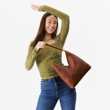 Nutmeg Large | Model holding mid-size shoulder bag with magnetic snap closure