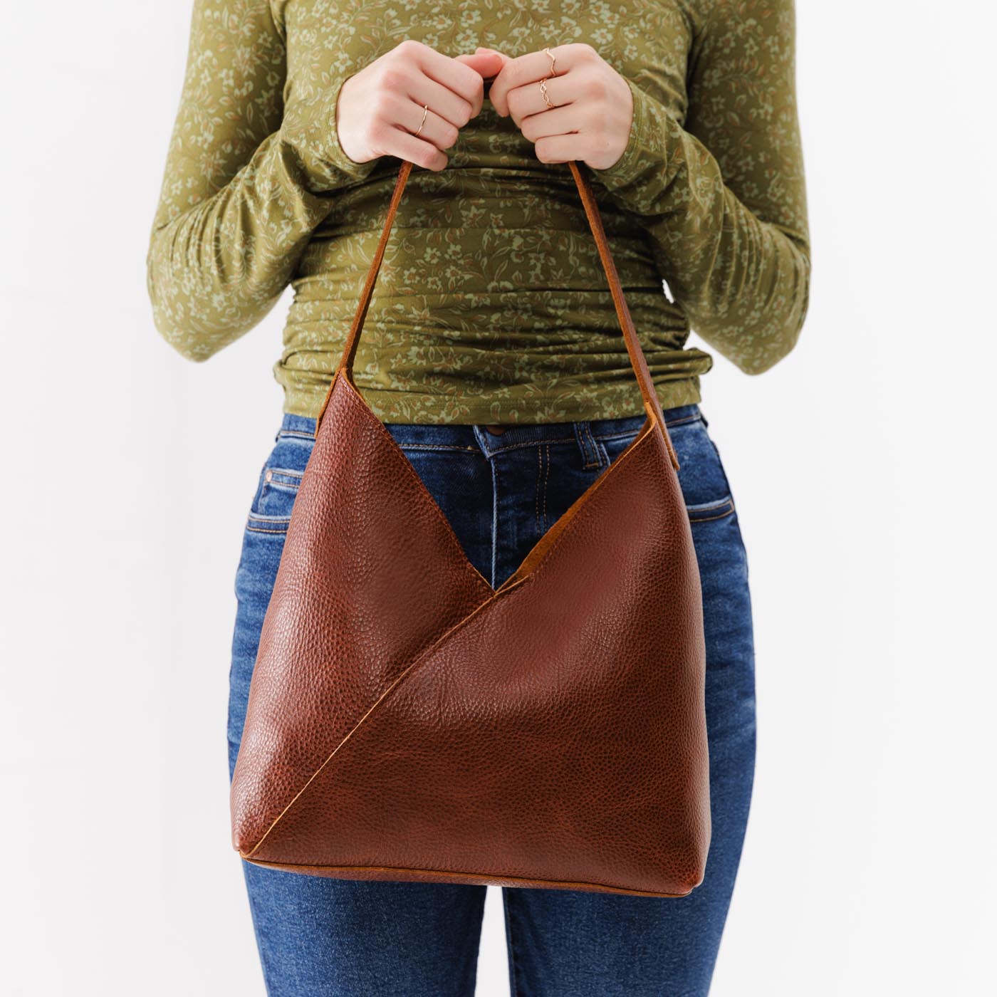 Nutmeg*Large | Model holding mid-size shoulder bag with magnetic snap closure